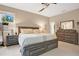 Serene main bedroom with a neutral palette, ceiling fan, natural light, and an elegant dresser at 7518 Tangle Brook Blvd, Gibsonton, FL 33534