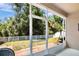Relax on the screened patio overlooking the expansive backyard with a charming white picket fence at 7518 Tangle Brook Blvd, Gibsonton, FL 33534