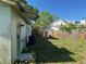 A view of a fenced backyard area with some trees for shade and a air conditioning unit at 8244 125Th St, Seminole, FL 33772