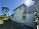 Back view of the home showing the sloped roof, trees, and backyard at 8244 125Th St, Seminole, FL 33772