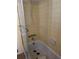 Bathroom tub and tile wall with retro sliding glass shower doors at 8244 125Th St, Seminole, FL 33772