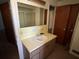 Bathroom vanity with a sink and storage, and a large mirror on the wall at 8244 125Th St, Seminole, FL 33772