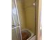 Bathroom tub featuring yellow tile walls and sliding glass door at 8244 125Th St, Seminole, FL 33772