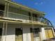 Close up on a two-story home with a wrought iron balcony and shutters at 8244 125Th St, Seminole, FL 33772