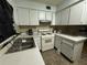 Features a stove and sink with white cabinets at 8244 125Th St, Seminole, FL 33772
