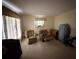 Living room with two armchairs, an ottoman, and neutral colored walls at 8244 125Th St, Seminole, FL 33772