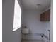 Functional laundry room with a window for natural light and cabinet storage at 8869 90Th Way, Seminole, FL 33777