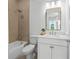 Bright bathroom with a shower-tub combo and modern vanity with stylish light fixtures at 8913 Bernini Pl, Sarasota, FL 34240