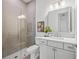 Modern bathroom with glass shower enclosure and white vanity with sleek fixtures at 8913 Bernini Pl, Sarasota, FL 34240