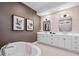 Spacious bathroom with freestanding tub, double vanity, and stylish wall decor at 8913 Bernini Pl, Sarasota, FL 34240