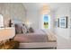 Serene bedroom with floral wallpaper, soft lighting, and a comfortable bed at 8913 Bernini Pl, Sarasota, FL 34240