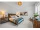Cozy bedroom featuring a comfortable bed with decorative pillows and stylish furnishings at 8913 Bernini Pl, Sarasota, FL 34240