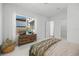 Bright bedroom with large window, woven basket, and wood dresser at 8913 Bernini Pl, Sarasota, FL 34240