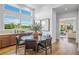 Bright dining room with hardwood floors, a round table with seating, and views of the outdoors at 8913 Bernini Pl, Sarasota, FL 34240