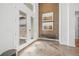 Elegant foyer with herringbone floors, large double doors, and decorative wall art at 8913 Bernini Pl, Sarasota, FL 34240