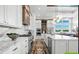 Gourmet kitchen featuring marble counters, stainless steel appliances, custom cabinets, and an open layout at 8913 Bernini Pl, Sarasota, FL 34240