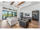 Bright living room with wood floors, vaulted ceilings, and a sliding glass door to the lanai at 8913 Bernini Pl, Sarasota, FL 34240