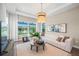 Cozy living room with a sectional sofa, large windows with a view, and stylish decor at 8913 Bernini Pl, Sarasota, FL 34240