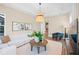 Inviting living room with a sectional sofa, warm lighting, stylish decor, and a relaxed atmosphere at 8913 Bernini Pl, Sarasota, FL 34240