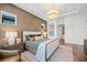 Relaxing main bedroom featuring natural light, hardwood floors, a comfortable bed, and stylish decor at 8913 Bernini Pl, Sarasota, FL 34240