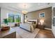 Serene bedroom with a large window, natural light, hardwood floors, and a comfortable bed at 8913 Bernini Pl, Sarasota, FL 34240