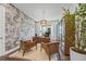 Stylish home office with unique wallpaper, custom shelving, and abundant natural light at 8913 Bernini Pl, Sarasota, FL 34240