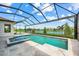 Screened in pool and hot tub with a lake view and water features at 8913 Bernini Pl, Sarasota, FL 34240