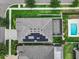 Aerial view of a home featuring solar panels, a screened lanai, and a private backyard pool at 1002 Cavour Ct, Brandon, FL 33511