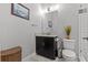 Well-lit powder room with granite counter, black vanity, and a toilet at 1002 Cavour Ct, Brandon, FL 33511