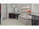 Bright bathroom with soaking tub, dark cabinets, granite counters and large window at 1002 Cavour Ct, Brandon, FL 33511