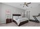 Bright bedroom with wood-look flooring, ceiling fan, and ensuite bathroom access at 1002 Cavour Ct, Brandon, FL 33511