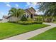 Beautifully landscaped home with lush lawn, mature trees, and manicured bushes at 1002 Cavour Ct, Brandon, FL 33511