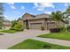 Lovely single-story home with well-maintained landscaping, brick paved driveway, and three-car garage at 1002 Cavour Ct, Brandon, FL 33511