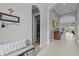 Inviting foyer with neutral paint, tile flooring, and an arched doorway leading to other living spaces at 1002 Cavour Ct, Brandon, FL 33511