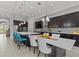 Open-concept kitchen featuring dark wood cabinets, center island with seating, and stainless steel appliances at 1002 Cavour Ct, Brandon, FL 33511