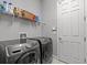 Laundry room with Samsung washer and dryer and overhead storage shelf at 1002 Cavour Ct, Brandon, FL 33511