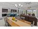Open-concept living and dining area features a modern kitchen with a breakfast bar and access to the outdoor patio at 1002 Cavour Ct, Brandon, FL 33511