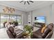 Bright living room with decorative wall hangings has a large sliding glass door leading to the outdoor space at 1002 Cavour Ct, Brandon, FL 33511