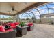 Screened-in patio with pavers, ceiling fans, an outdoor seating area with red cushions at 1002 Cavour Ct, Brandon, FL 33511