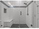 Modern bathroom shower featuring white subway tile, a shower bench, and a glass door at 1002 Cavour Ct, Brandon, FL 33511