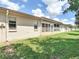 The exterior shows the backyard with sliding glass doors leading to an enclosed lanai for relaxed indoor/outdoor living at 1041 Bowsprit Ln # 1041, Holiday, FL 34691