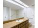 Well-lit bathroom with a wooden vanity and tiled floor at 1041 Bowsprit Ln # 1041, Holiday, FL 34691