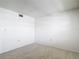 This bedroom features neutral carpet flooring, white walls, and outlets at 1041 Bowsprit Ln # 1041, Holiday, FL 34691