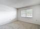 Comfortable bedroom with a large window and neutral carpet at 1041 Bowsprit Ln # 1041, Holiday, FL 34691