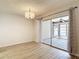 Bright dining area features decorative curtains and a glass sliding door leading to screened patio at 1041 Bowsprit Ln # 1041, Holiday, FL 34691