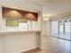 Dining room with breakfast bar, modern lighting, and sliding door to the patio at 1041 Bowsprit Ln # 1041, Holiday, FL 34691