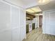 Bright kitchen with wood cabinets, tiled floor, and white appliances at 1041 Bowsprit Ln # 1041, Holiday, FL 34691