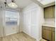 Kitchen area showcasing white pantry doors, light wood cabinets, and tile flooring at 1041 Bowsprit Ln # 1041, Holiday, FL 34691