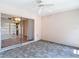 This lanai features neutral tile floors, ceiling fan, and a large sliding door at 1041 Bowsprit Ln # 1041, Holiday, FL 34691