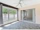 Lanai with tile floor, multiple windows, and a sliding door entrance to a room at 1041 Bowsprit Ln # 1041, Holiday, FL 34691